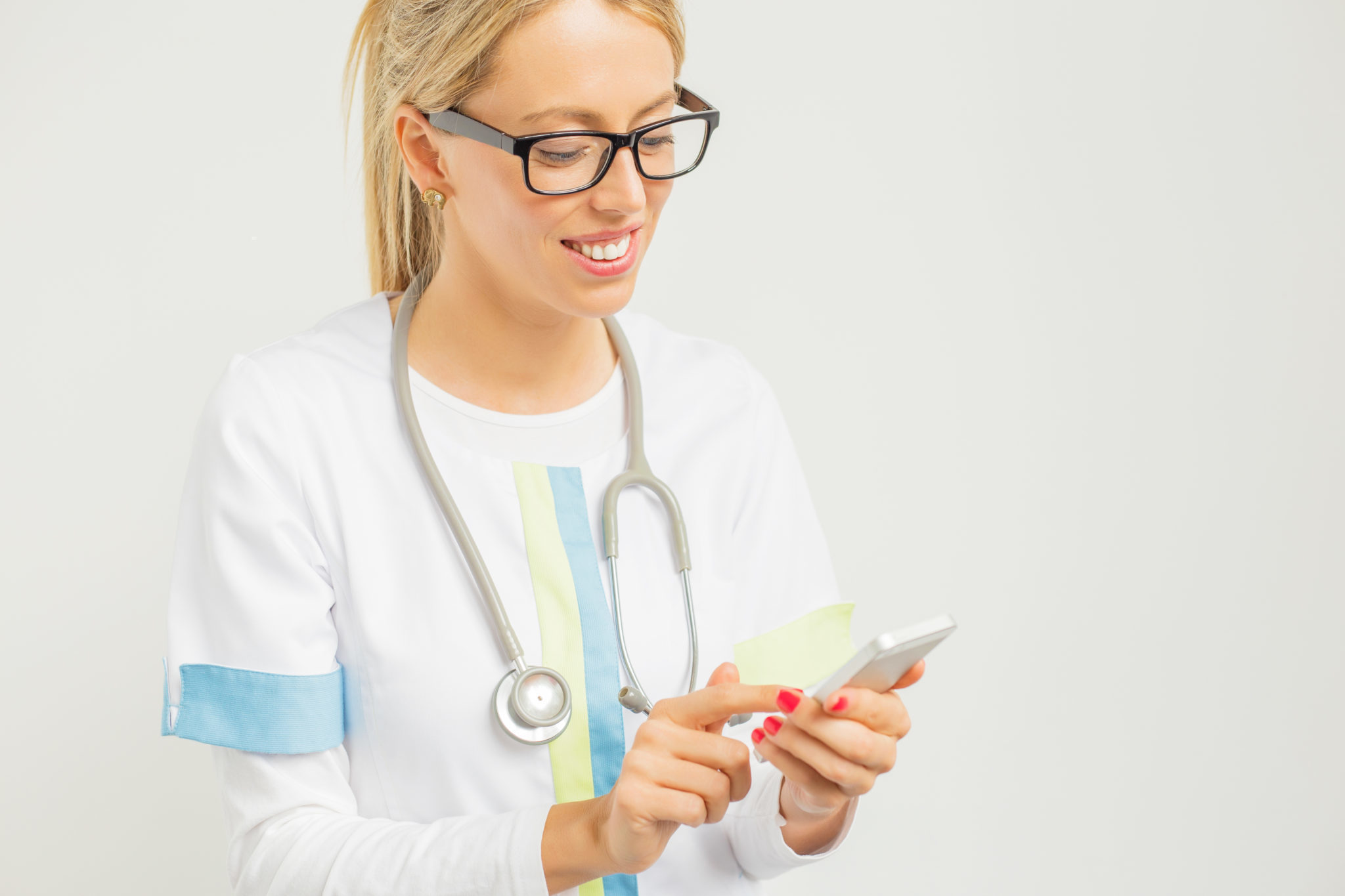 Female physician using smart phone 2048 x 1365
