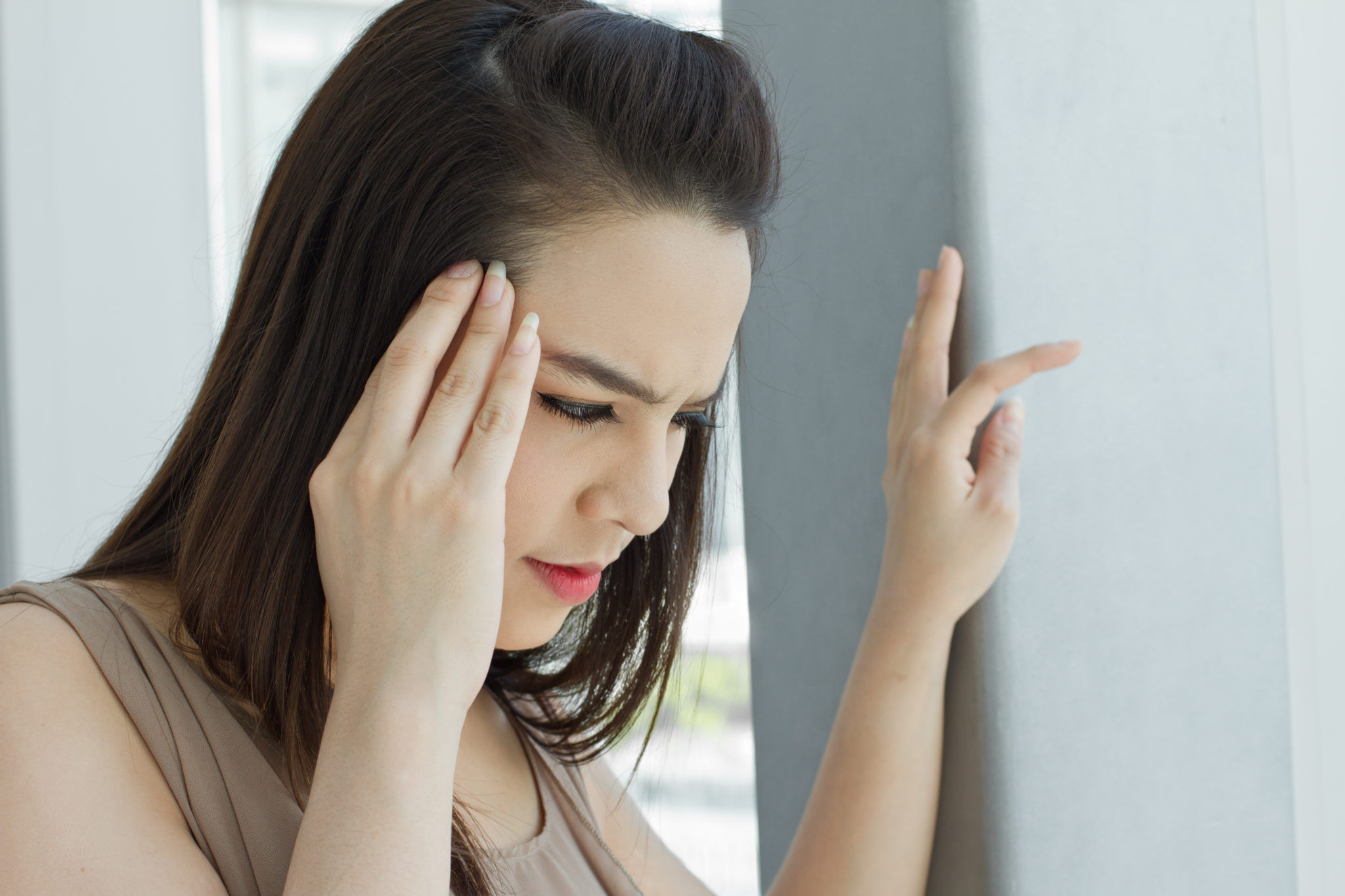 woman with headache, migraine, stress, insomnia, hangover in casual dress 2048 x 1365