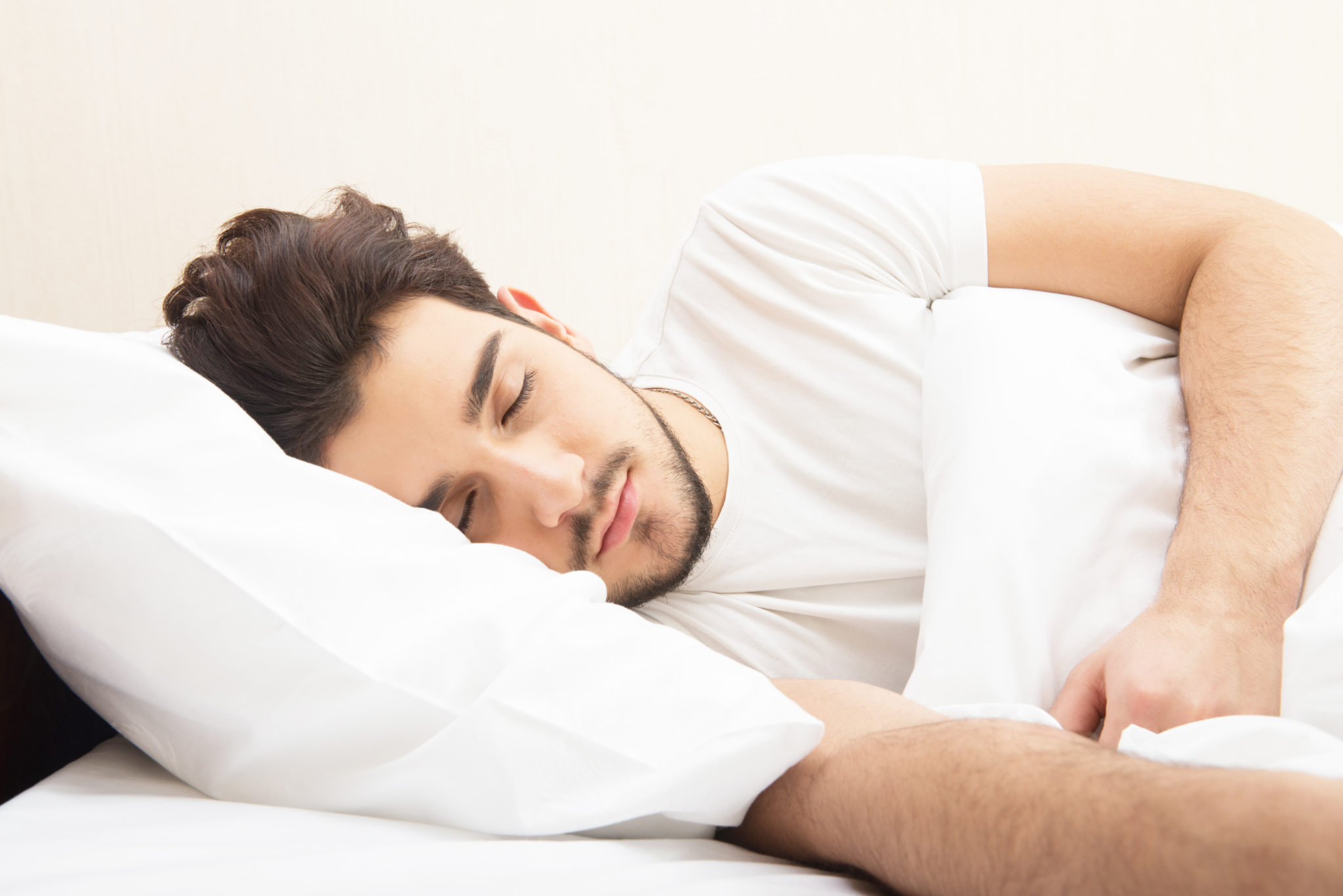 young man sleeping in bed 2048 x 1367