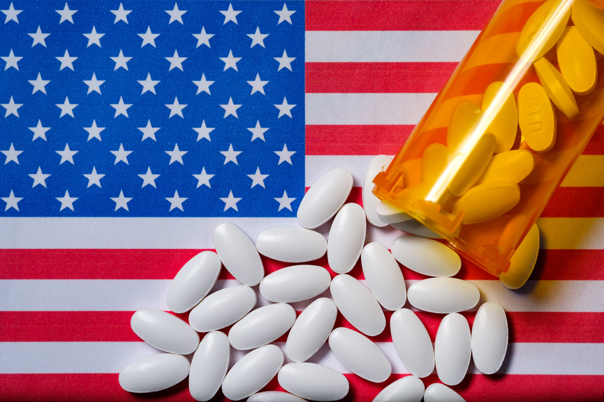 White prescription pills on US flag background 2048 x 1365