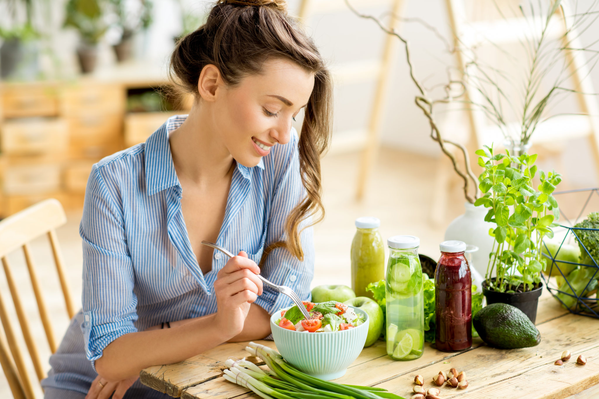 Young woman at sunny table eating healthy food 2048 x 1367