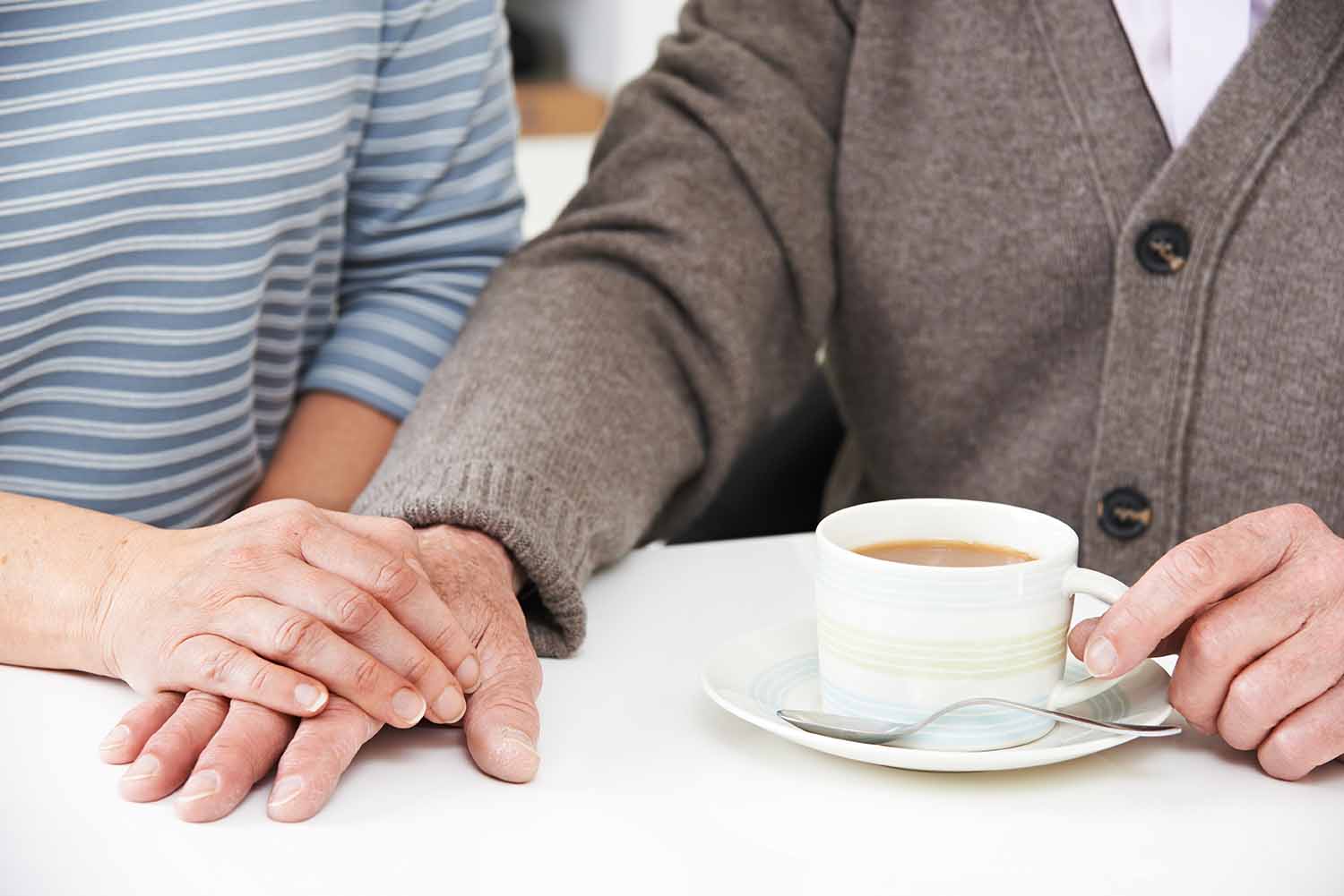 Daughter sharing tea with aging father