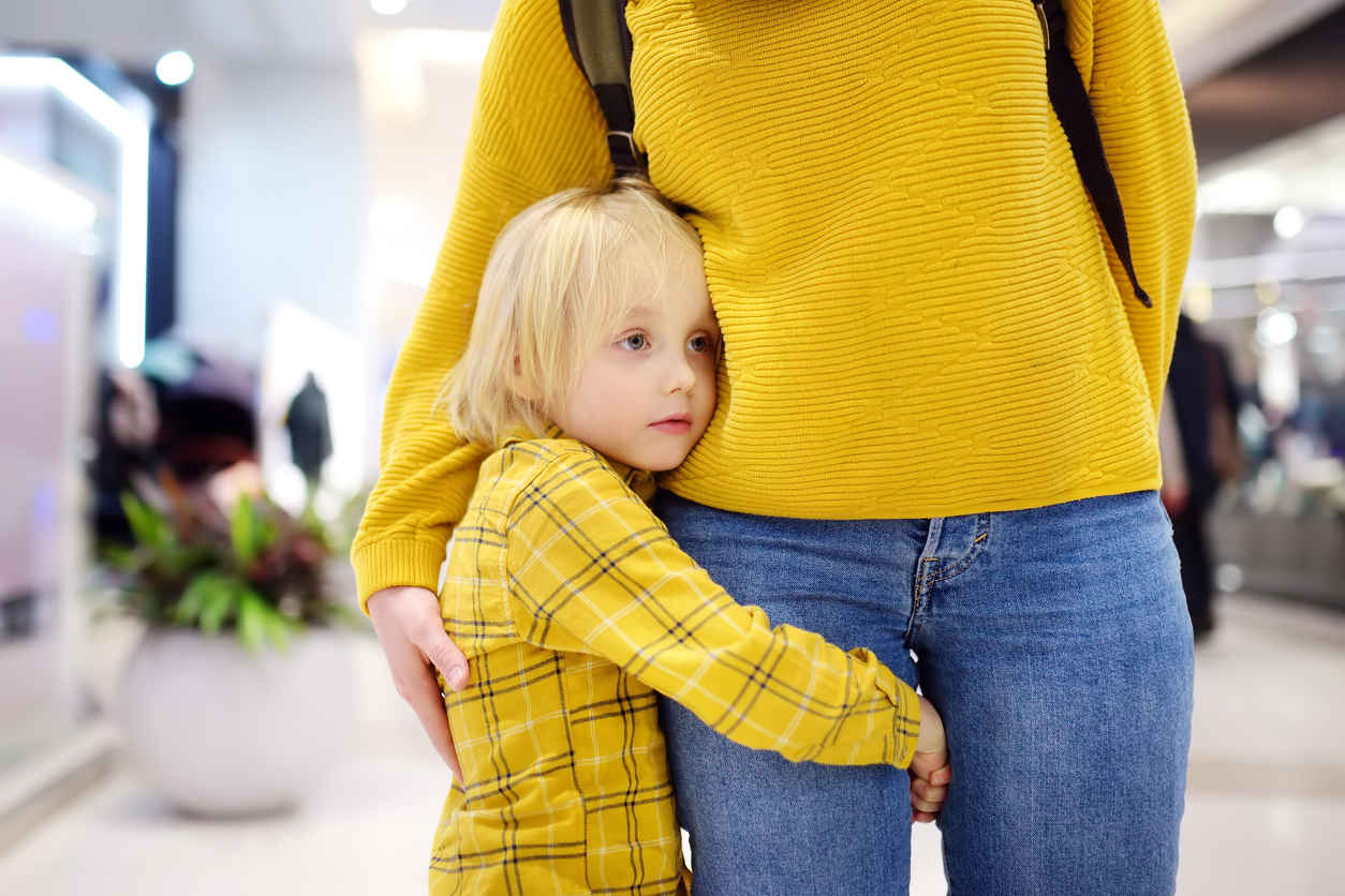 anxiety in children - child clinging to moms leg