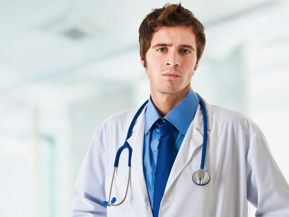 Worried doctor with white coat & stethoscope 1000 x 750
