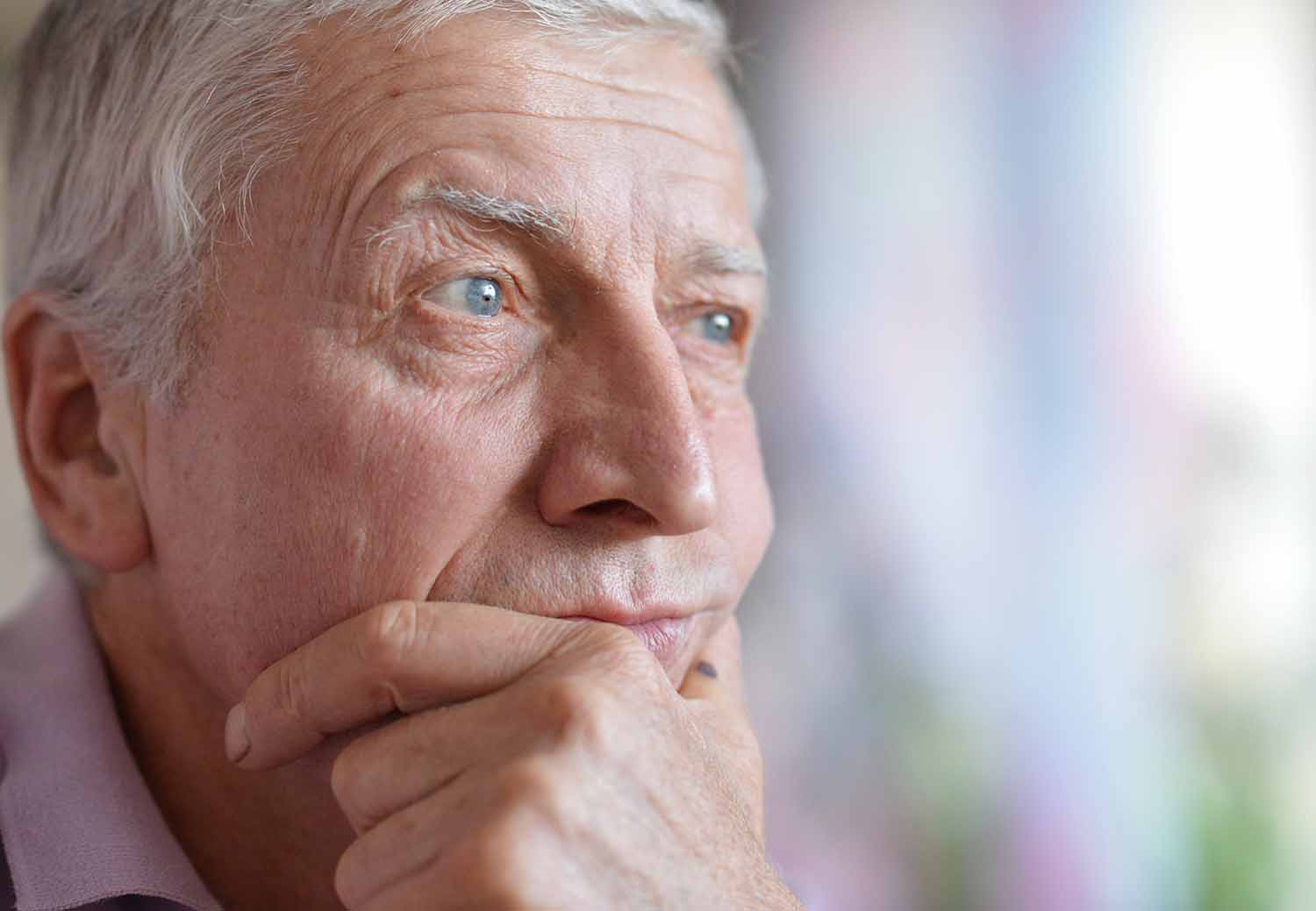 close-up portrait of a senior man thinking about something 1500 x 1039
