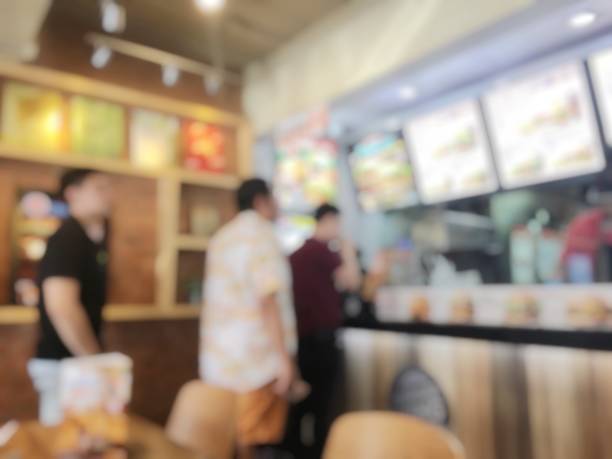 blurred image of people standing in line in fast food restaurant (612 x 459)