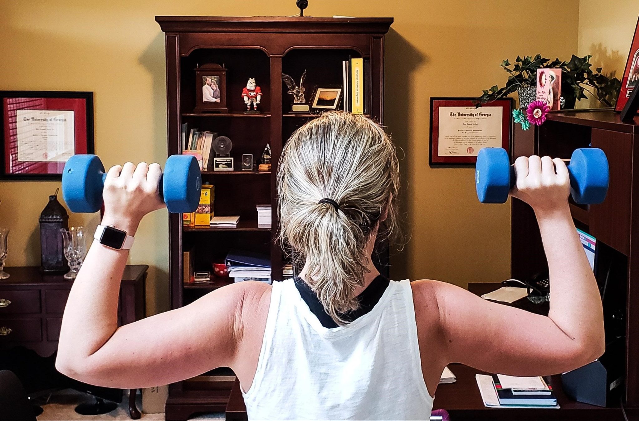 woman lifting weights one-minute exercise (no time for exercise)