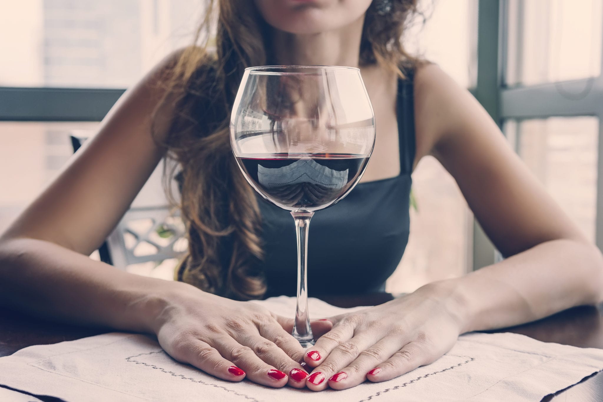 close up of woman drinking red wine (alcohol)