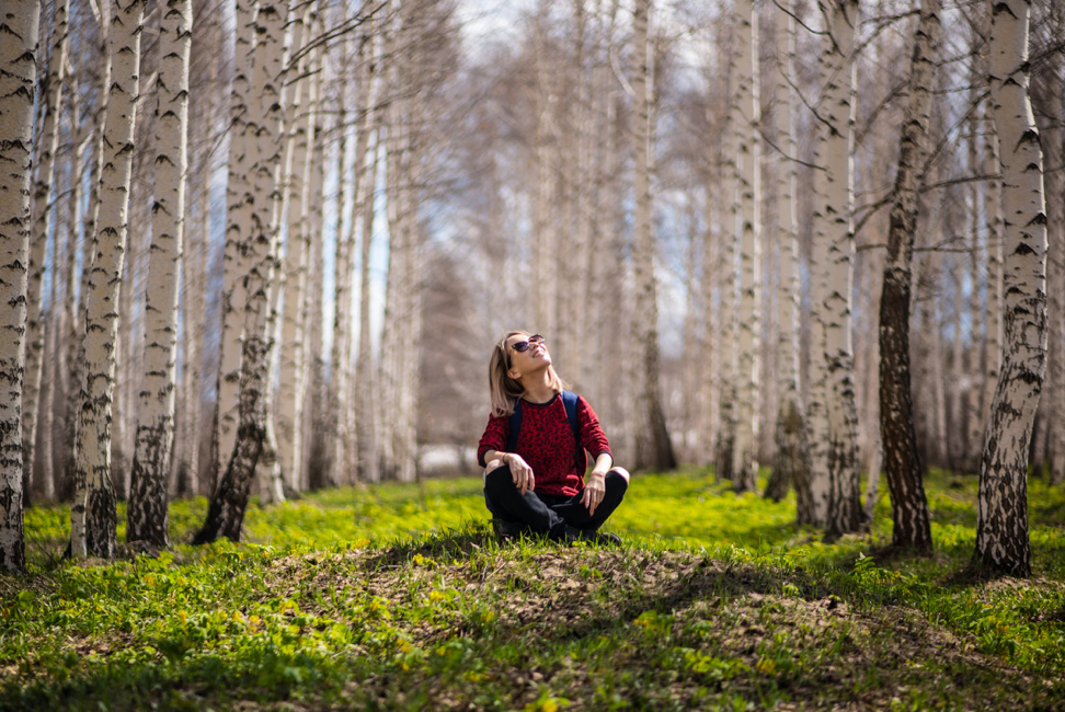 nature deficit disorder (woman sitting in forest)