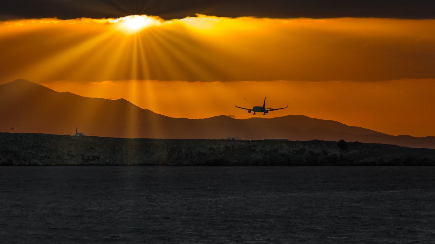 airplane landing at sunset 1500 x 843