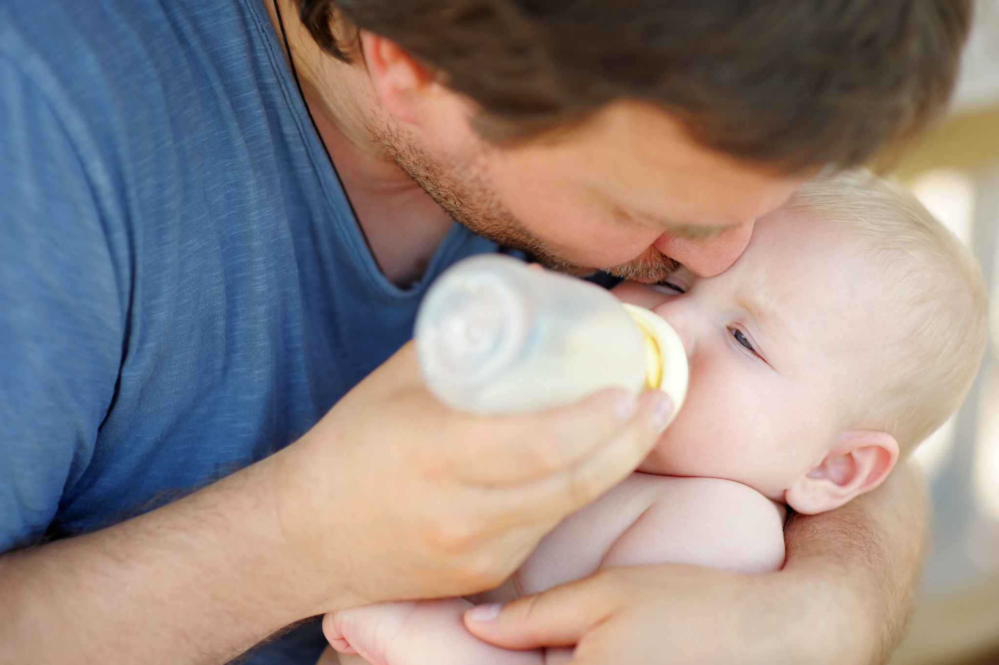 dietary guidelines dad giving baby milk bottle