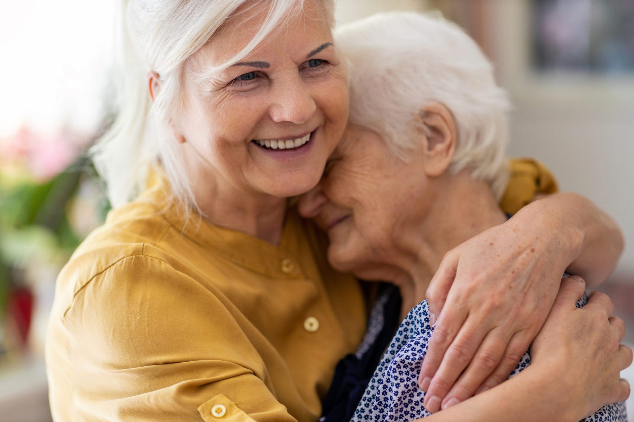senior woman hugging elderly mom - emotional health