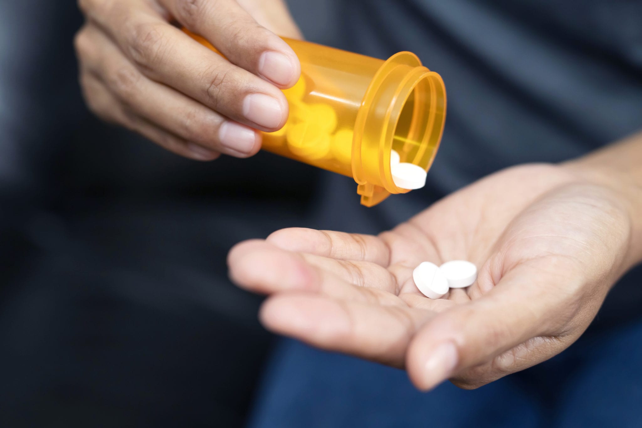 shaking pills from bottle into open hand (safe prescribing)