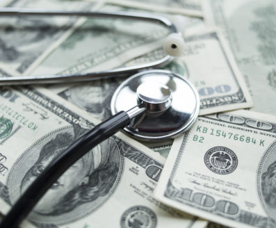 stethoscope on dollar bills (uninsured crisis)