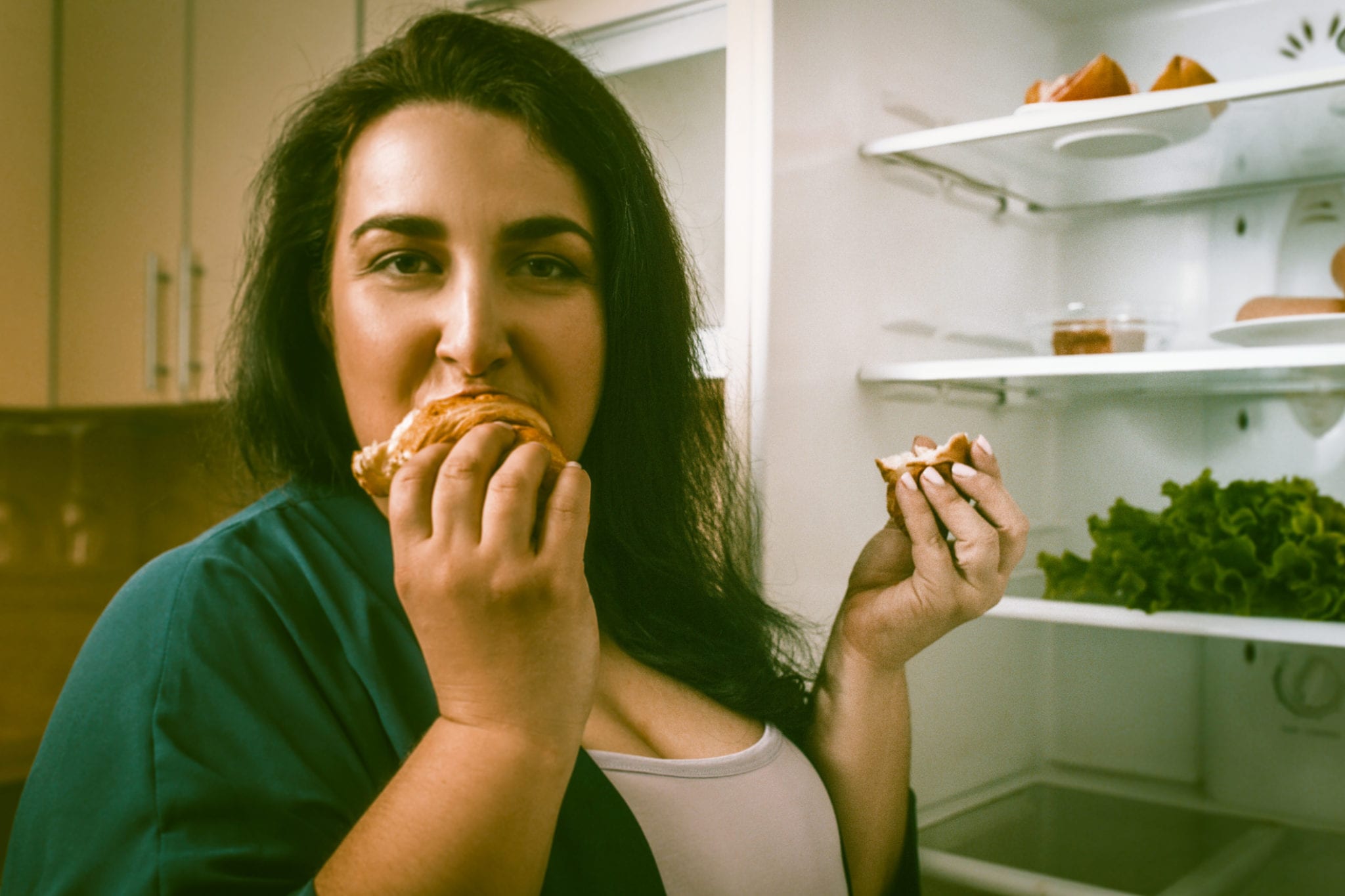 Woman eating fattening food her ignoring doctor's weight loss advice